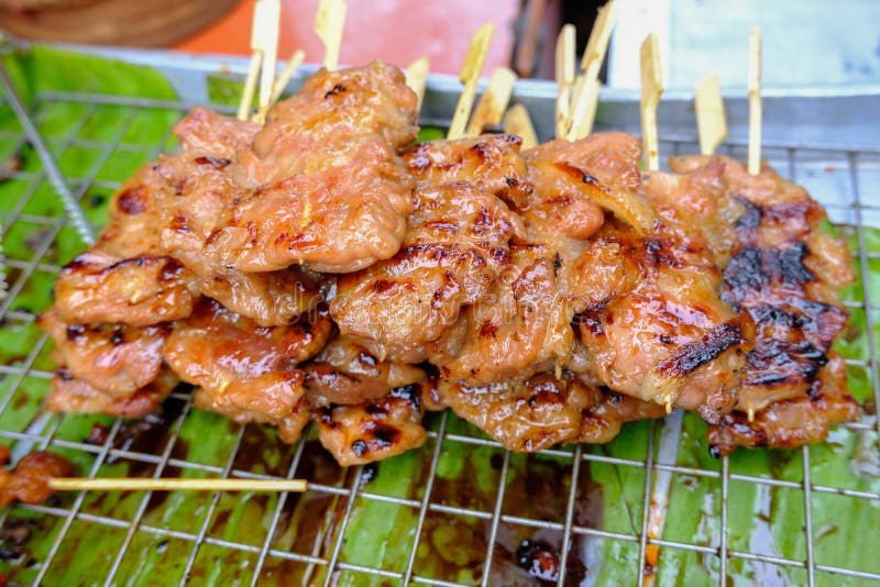 Premium Photo  Closeup of grilled skewered milk pork on stick thai street  food market