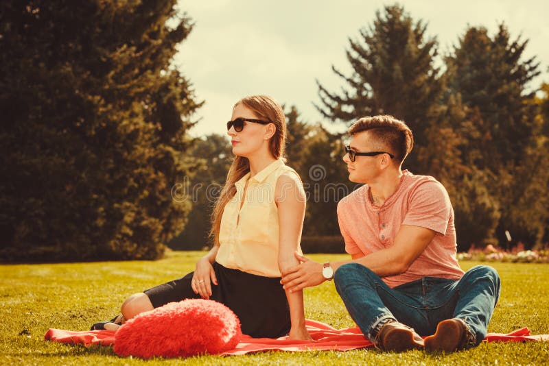 Moody girl with boyfriend in park. royalty free stock images Moody girl with boyfriend in park. royalty free stock images