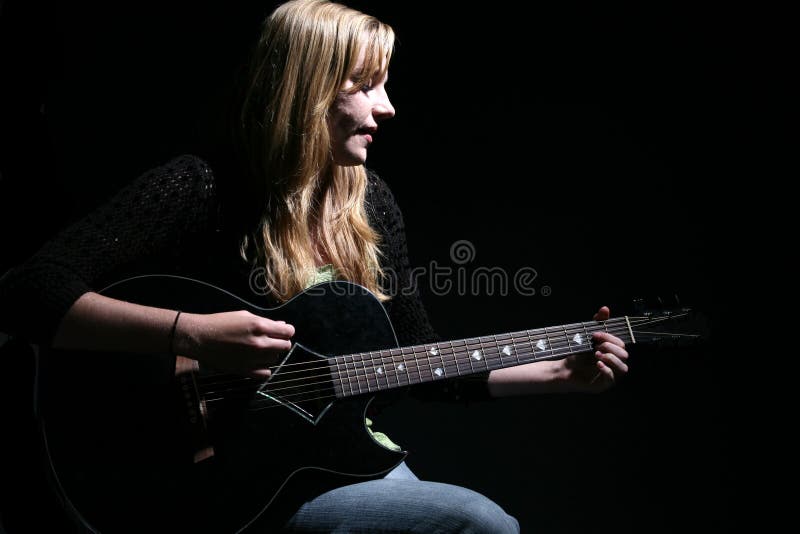 Moody woman playing guitar and singing