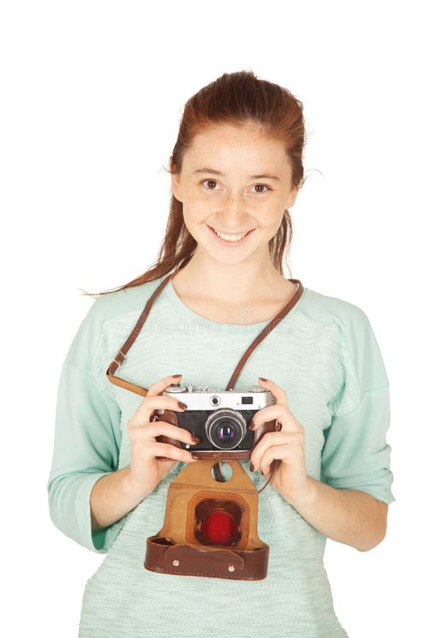 Mooi grappig freckled tienermeisje, 17-18 jaar oud, met retro camera in haar die handen, op witte achtergrond worden geïsoleerd royalty-vrije stock foto Mooi grappig freckled tienermeisje, 17-18 jaar oud, met retro camera in haar die handen, op witte achtergrond worden geïsoleerd royalty-vrije stock foto