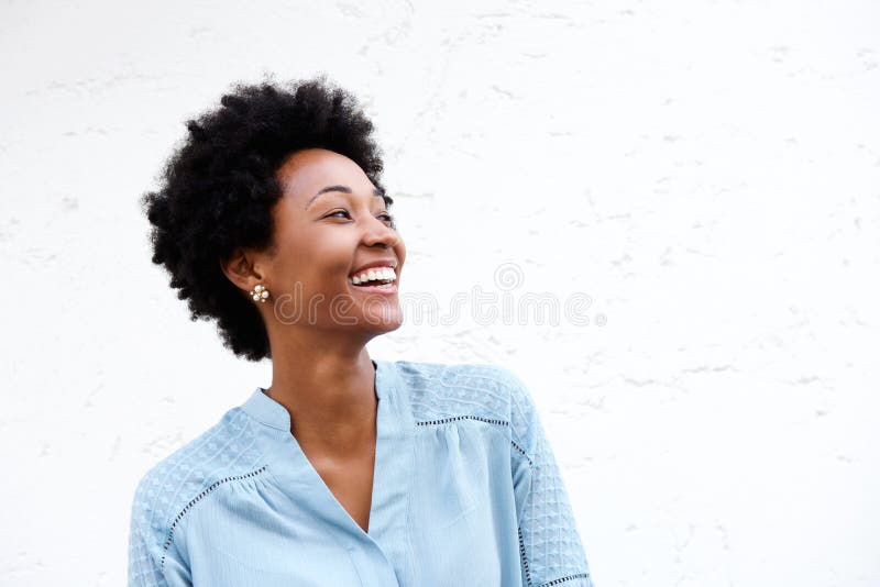 Close up portrait of beautiful young black woman looking away and smiling against white background. Close up portrait of beautiful young black woman looking away and smiling against white background