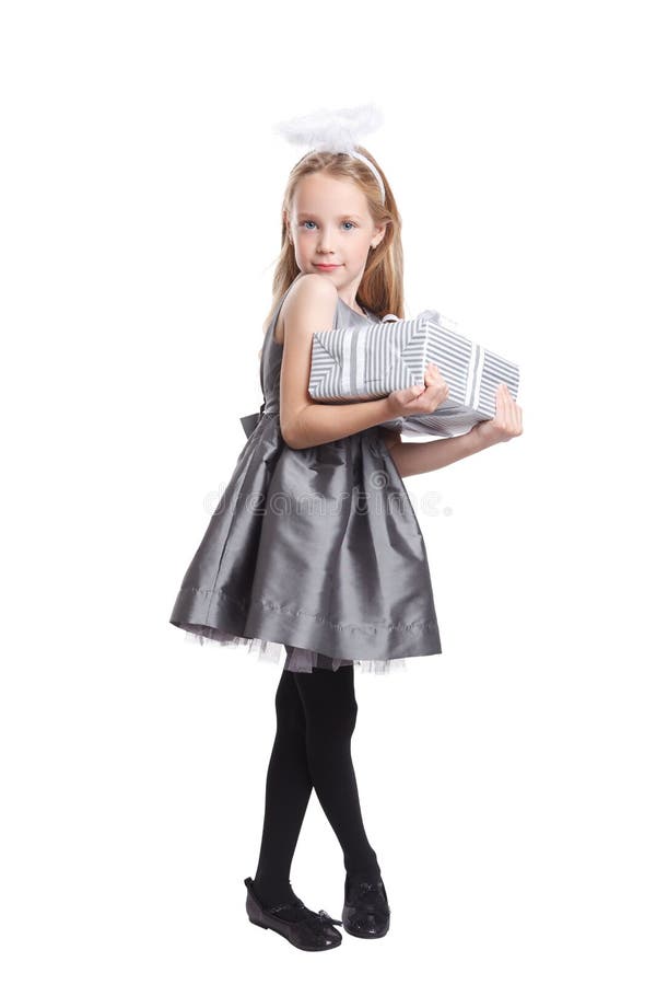 Cute little girl holding a Christmas present isolated on white. Cute little girl holding a Christmas present isolated on white