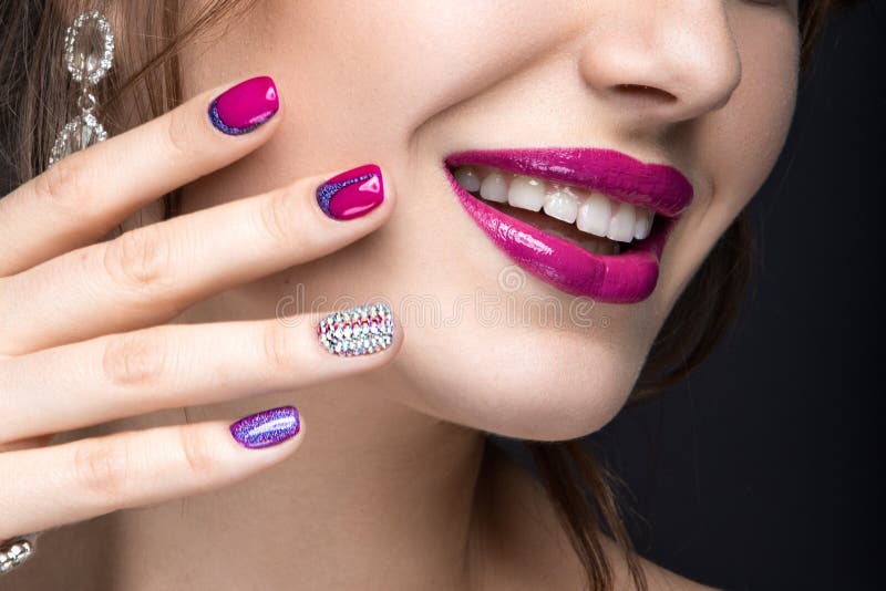 Mooi meisje met een heldere avondsamenstelling en een roze manicure met bergkristallen Spijkerontwerp Het Gezicht van de schoonhe stock afbeelding Mooi meisje met een heldere avondsamenstelling en een roze manicure met bergkristallen Spijkerontwerp Het Gezicht van de schoonhe stock afbeelding