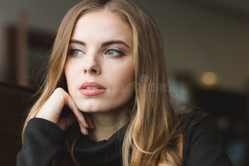 Closeup portrait of beautiful pensive young blonde female looking away. Closeup portrait of beautiful pensive young blonde female looking away