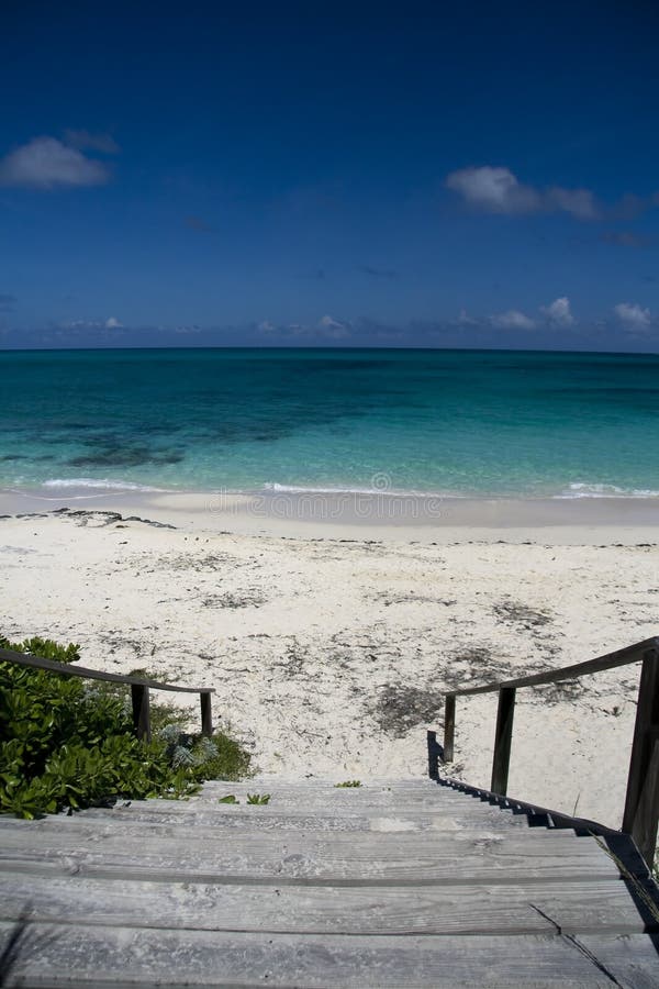 Wooden step entrance to a beautiful tropical beach. Wooden step entrance to a beautiful tropical beach.