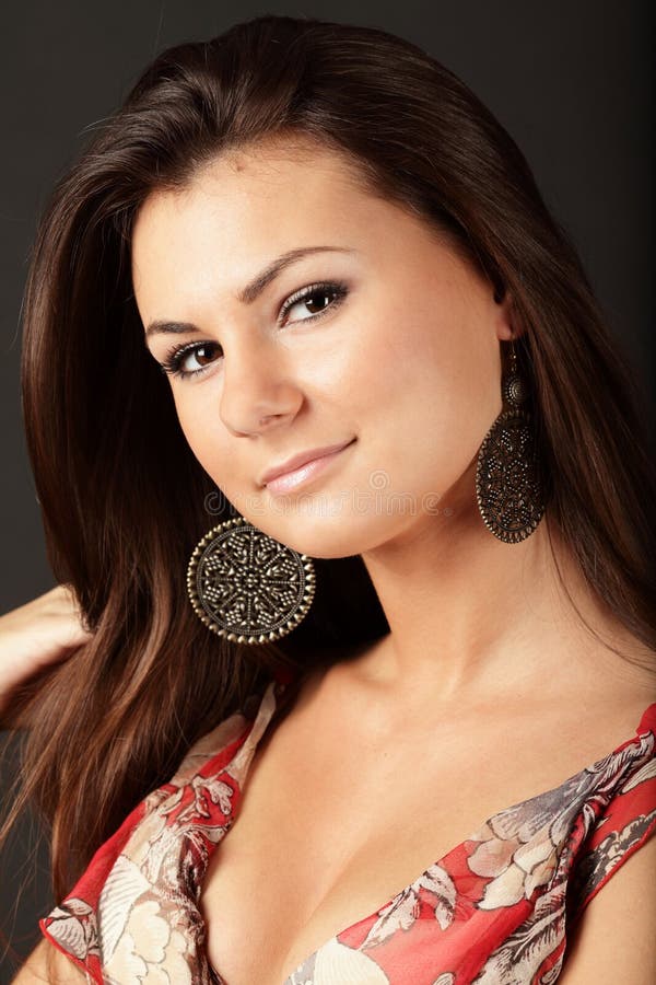 Portrait of a beautiful brunette woman with nice earrings. Portrait of a beautiful brunette woman with nice earrings