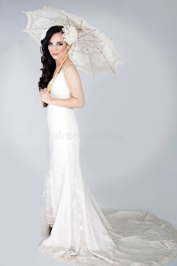 Mooie elegante vrouw in het witte huwelijkskleding stellen royalty-vrije stock foto's Mooie elegante vrouw in het witte huwelijkskleding stellen royalty-vrije stock foto's