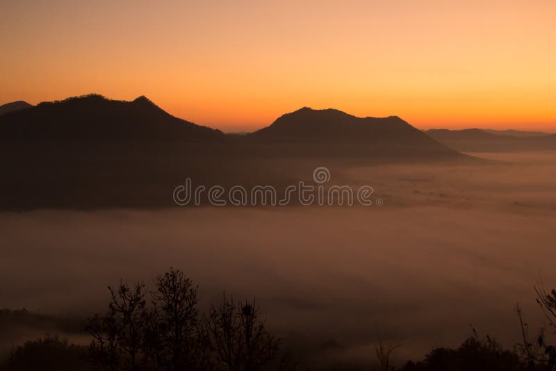 Mooie hemelzonsopgang Berglaag in de straal van de ochtendzon en de wintermist stock fotografie Mooie hemelzonsopgang Berglaag in de straal van de ochtendzon en de wintermist stock fotografie
