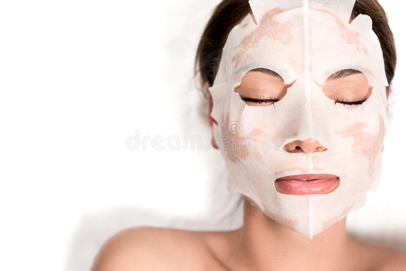 beautiful young woman in mask on face relaxing with closed eyes in spa salon. beautiful young woman in mask on face relaxing with closed eyes in spa salon