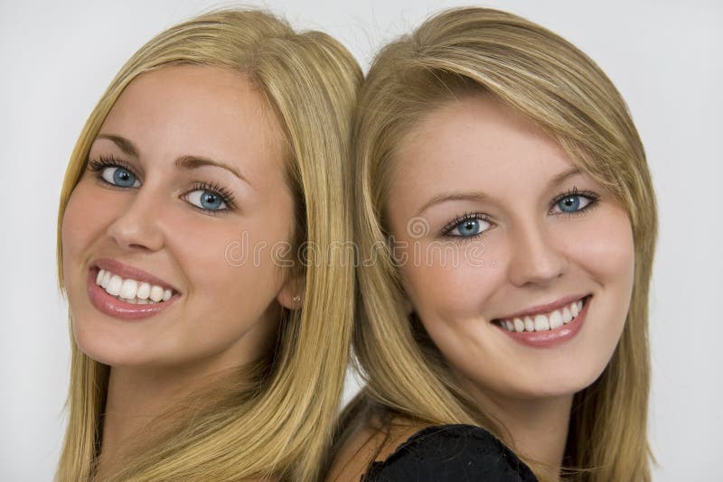 Two beautiful young women with beautiful blue eyes and lovely toothy smiles. Two beautiful young women with beautiful blue eyes and lovely toothy smiles