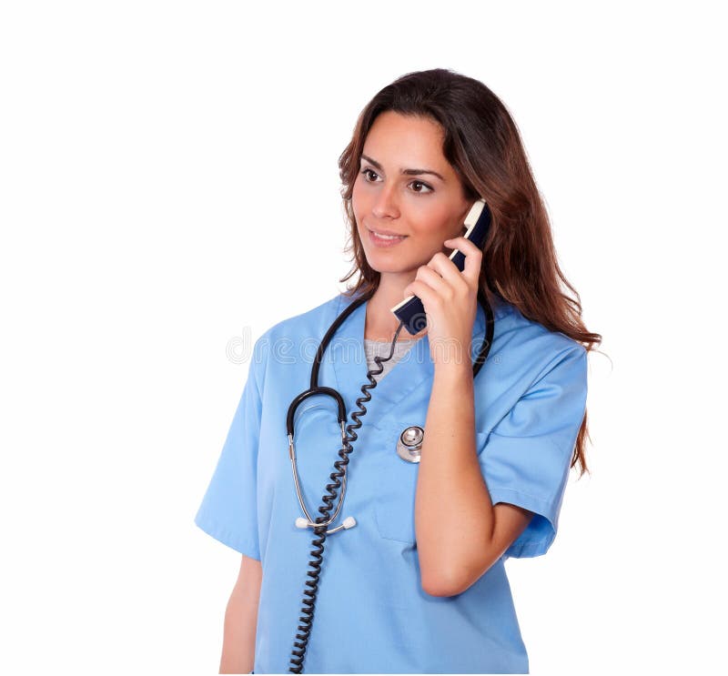 A portrait of beautiful nurse with blue uniform speaking on the phone on isolated studio - copyspace. A portrait of beautiful nurse with blue uniform speaking on the phone on isolated studio - copyspace