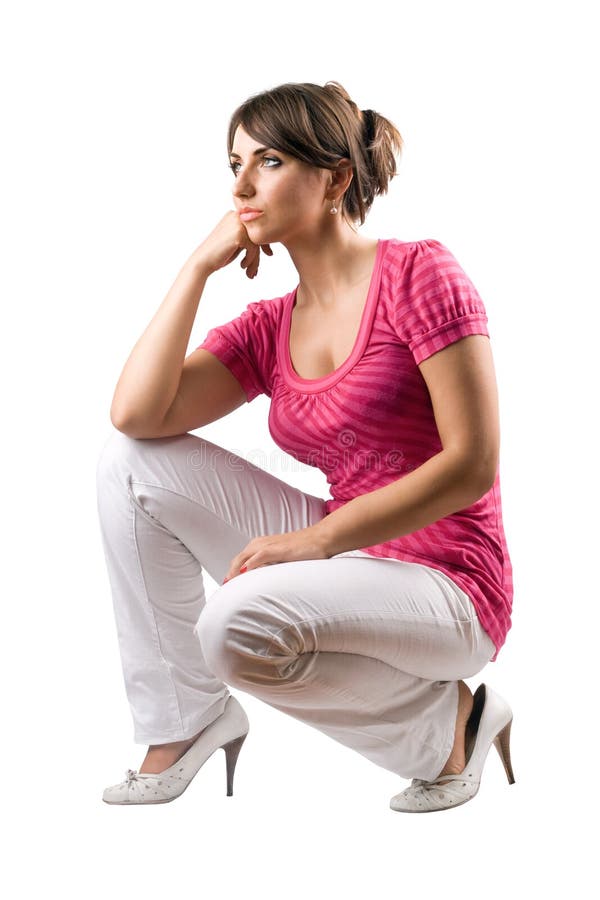 Thoughtful pretty woman in the squatting position. Isolated. Thoughtful pretty woman in the squatting position. Isolated