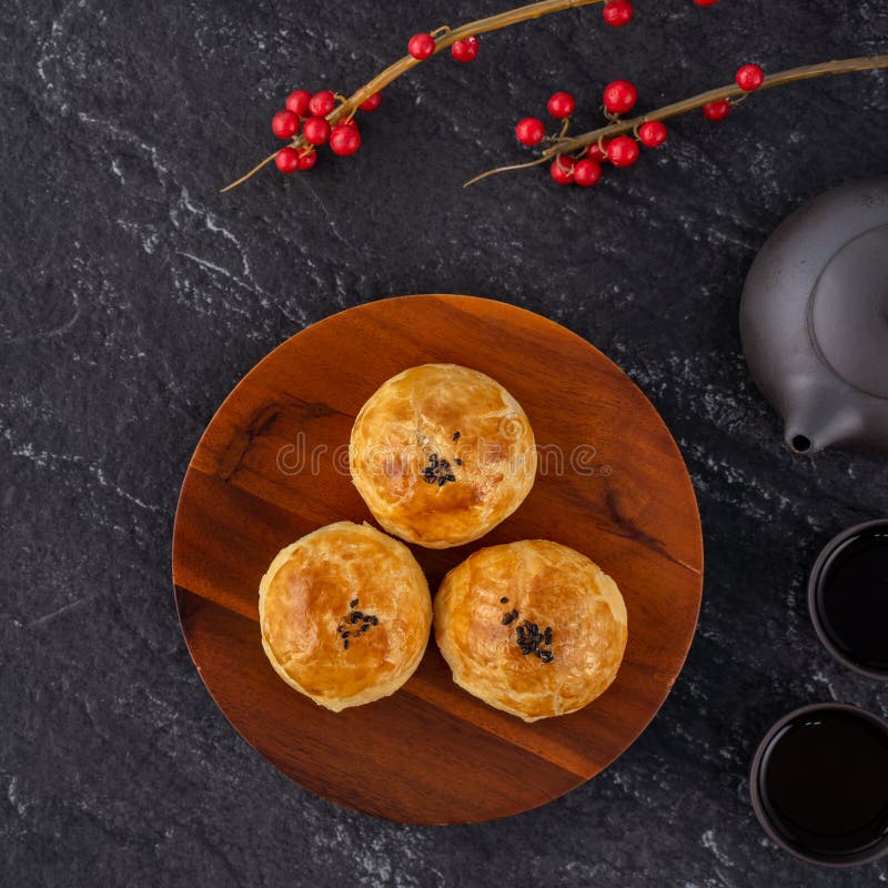Moon cake yolk pastry, mooncake for Mid-Autumn Festival holiday. Top view design concept on dark wooden table with copy space, flat lay, overhead shot royalty free stock photo Moon cake yolk pastry, mooncake for Mid-Autumn Festival holiday. Top view design concept on dark wooden table with copy space, flat lay, overhead shot royalty free stock photo