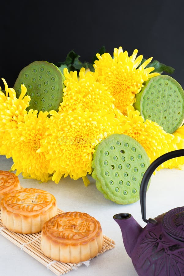 Mooncakes, teapot, chrysanthemum flowers, lotus seeds in pods on white background. Chinese mid-autumn festival food. stock image Mooncakes, teapot, chrysanthemum flowers, lotus seeds in pods on white background. Chinese mid-autumn festival food. stock image
