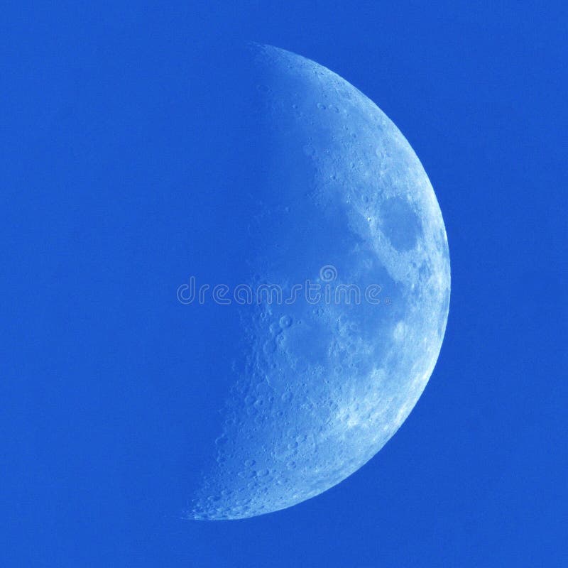 Moon details and clouds on blue sky