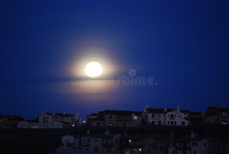 Moon over roof tops