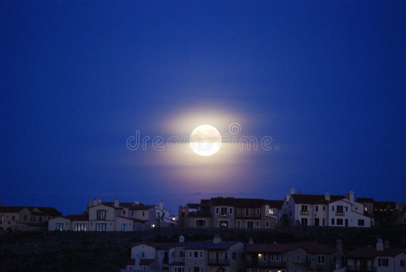 Moon over roof tops