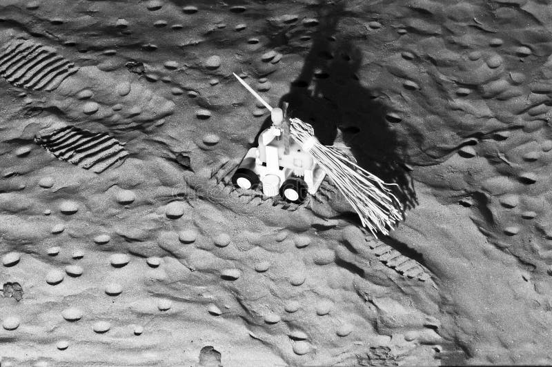 Moon rover covering the astronauts` tracks on lunar soil stock photo Moon rover covering the astronauts` tracks on lunar soil stock photo