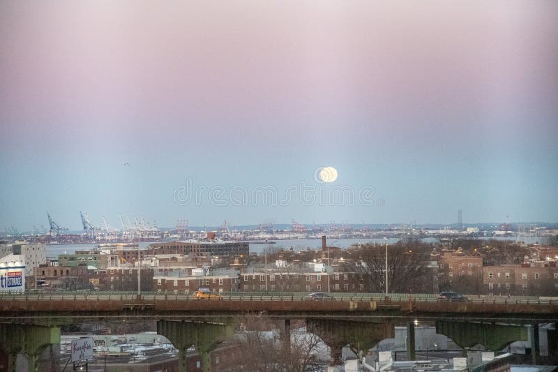 The Moon sets behind the elevated portion of the Brooklyn Queens Expressway stock photos