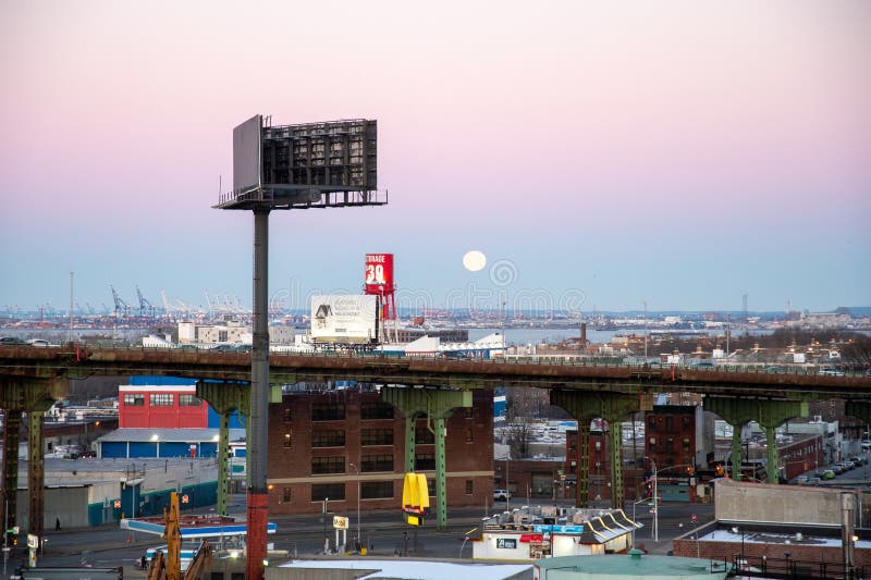 The Moon sets behind the elevated portion of the Brooklyn Queens Expressway royalty free stock photos