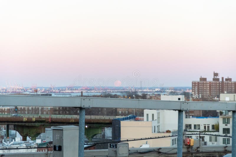 The Moon sets behind the elevated portion of the Brooklyn Queens Expressway stock photography