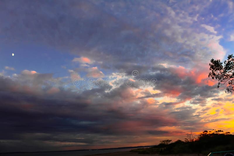 Moon and Sunset after a Rain Storm royalty free stock image Moon and Sunset after a Rain Storm royalty free stock image