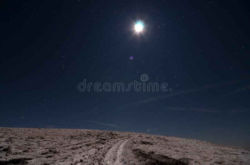 Moon över den snöig banan royaltyfri bild