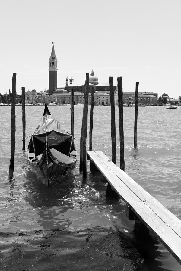 Moored gondola and San Giorgio di Maggiore church in Venice stock images Moored gondola and San Giorgio di Maggiore church in Venice stock images