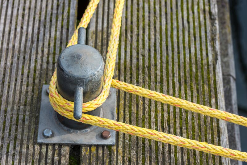 Mooring rope tied around a cleat stock image Mooring rope tied around a cleat stock image