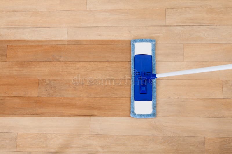 Mop cleaning a wooden floor stock image Mop cleaning a wooden floor stock image