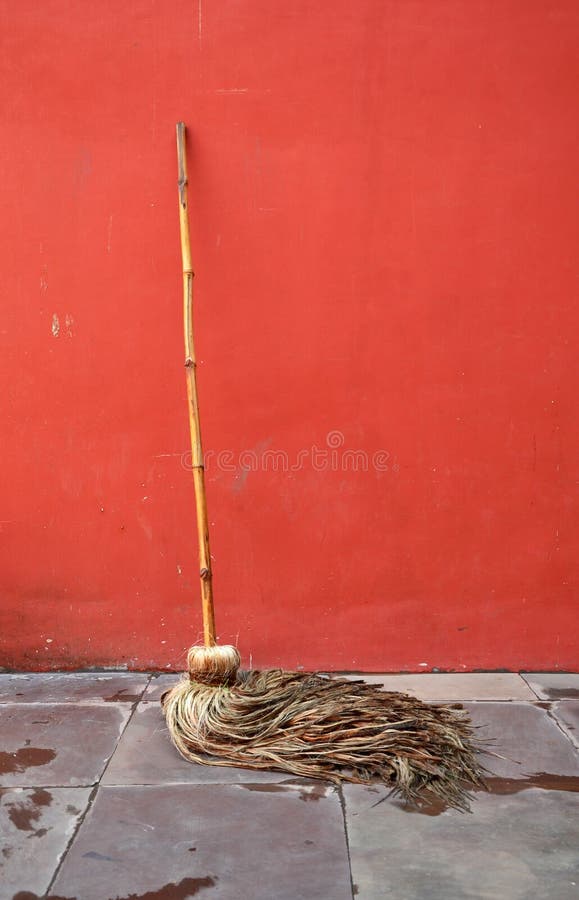 Mop lean against red wall stock photo. Image of mopping 51348550
