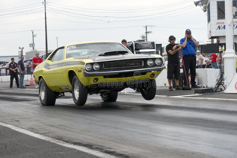 Napierville dragway july 12, 2014 picture of yellow dodge challenger rt at the starting line during nhra national open event. Napierville dragway july 12, 2014 picture of yellow dodge challenger rt at the starting line during nhra national open event.