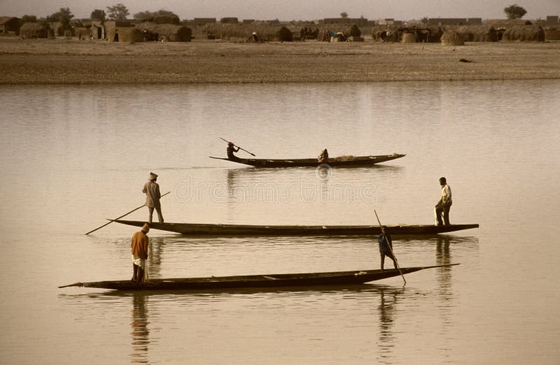 Mopti, Mali, Africa - January, 26, 1992 - the Bani River flows into the Niger River, pirogues and fish markets along the port. Mopti, Mali, Africa - January, 26, 1992 - the Bani River flows into the Niger River, pirogues and fish markets along the port