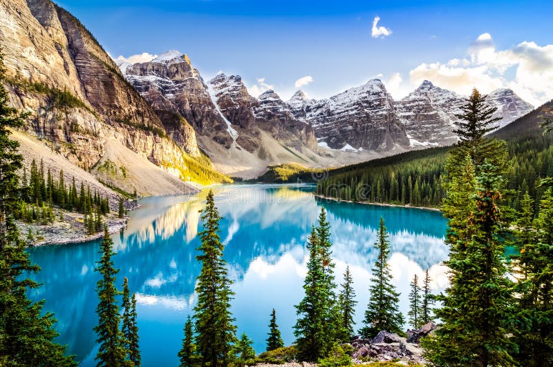 Landscape view of Moraine lake and mountain range at sunset in Rocky Mountains, Canada. Landscape view of Moraine lake and mountain range at sunset in Rocky Mountains, Canada