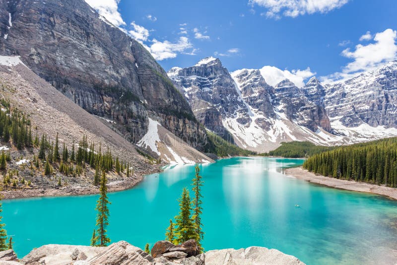 Beautiful Moraine lake in Banff National Park, Canadian Rockies, Canada. Sunny summer day with amazing blue sky. Majestic mountains in the background. Clear turquoise blue water. Hiker`s dream. Beautiful Moraine lake in Banff National Park, Canadian Rockies, Canada. Sunny summer day with amazing blue sky. Majestic mountains in the background. Clear turquoise blue water. Hiker`s dream.