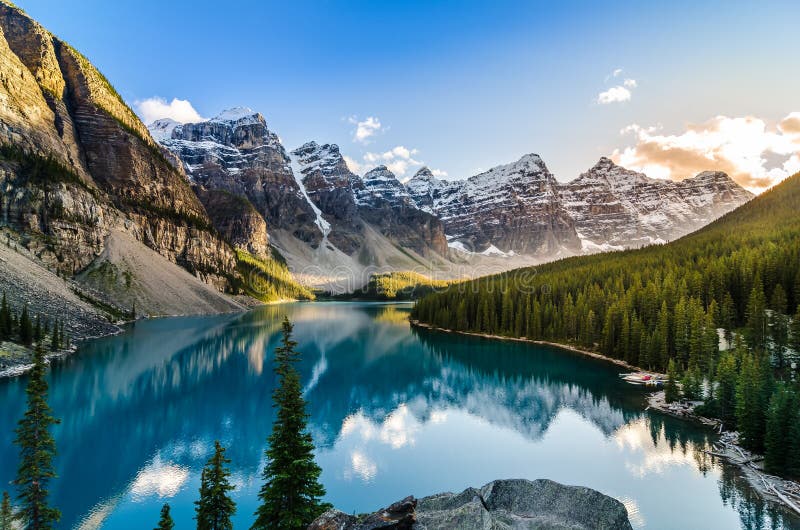 Landscape view of Moraine lake and mountain range at sunset in Canadian Rocky Mountains. Landscape view of Moraine lake and mountain range at sunset in Canadian Rocky Mountains