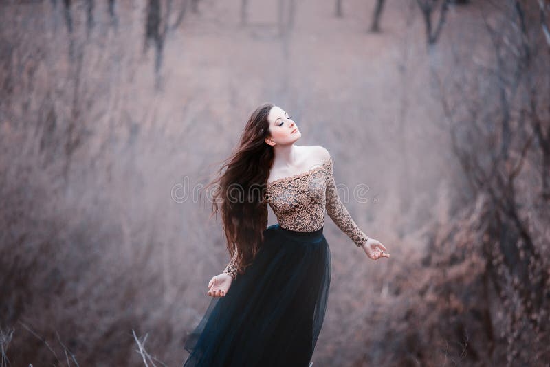 Morena macia surpreendente, senhora em um vestido preto longo com os braços e os ombros abertos desencapados, menina apenas no fr imagens de stock royalty free