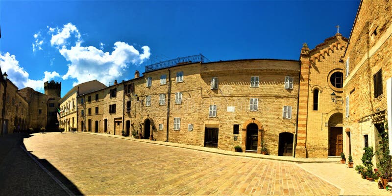 Moresco town in Fermo province, Marche region, Italy. Ancient square, church, tower and blue sky