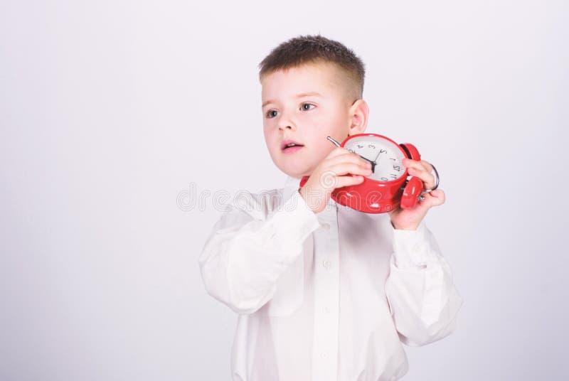 Morgenprogramm Sch?ler mit Wecker Hemdes des Kinderrote Fliege des entz?ckenden Jungen wei?en Entwickeln Sie Selbstdisziplin Ganz stockbilder Morgenprogramm Sch?ler mit Wecker Hemdes des Kinderrote Fliege des entz?ckenden Jungen wei?en Entwickeln Sie Selbstdisziplin Ganz stockbilder