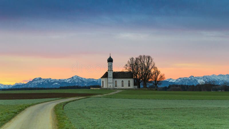 Morning Alpine landscape with sunrise over St. Andreas chapel