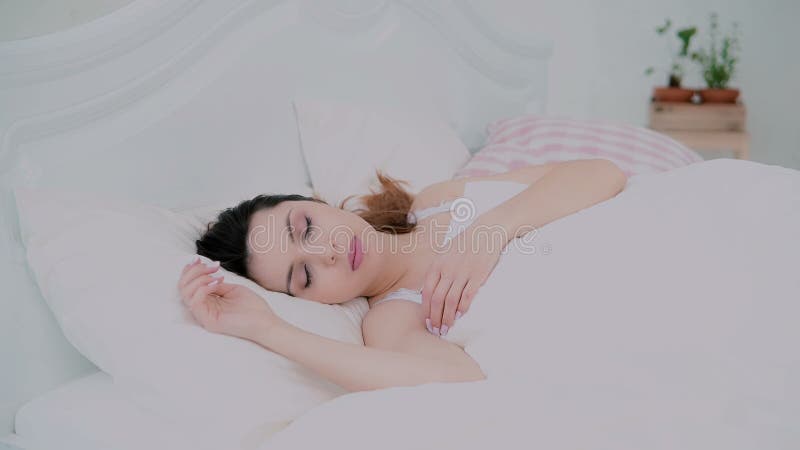 Morning of beautiful girl in light apartments. Young woman lying in bed, waking up and smile. Female looking at camera. stock photos Morning of beautiful girl in light apartments. Young woman lying in bed, waking up and smile. Female looking at camera. stock photos