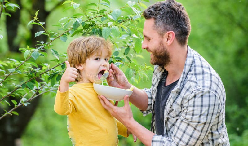 Morning breakfast. happy fathers day. Little boy with dad eat cereal. healthy food and dieting. Dairy products. son and stock image Morning breakfast. happy fathers day. Little boy with dad eat cereal. healthy food and dieting. Dairy products. son and stock image
