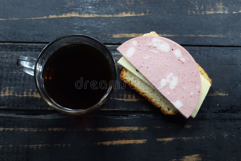 Morning Breakfast, Tea and a Sandwich with Sausage and Cheese Stock
