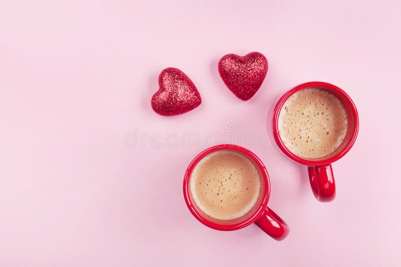 Morning breakfast for Valentines day. Two cups of coffee and red hearts on pink background top view. Flat lay royalty free stock photo Morning breakfast for Valentines day. Two cups of coffee and red hearts on pink background top view. Flat lay royalty free stock photo