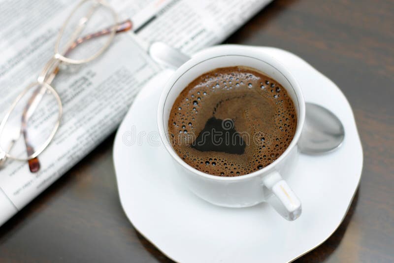 Cup of coffee, news and glasses on the table. Cup of coffee, news and glasses on the table.