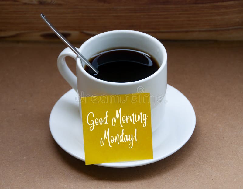 Morning greetings text on yellow notepad on coffee cup - Good morning Monday.