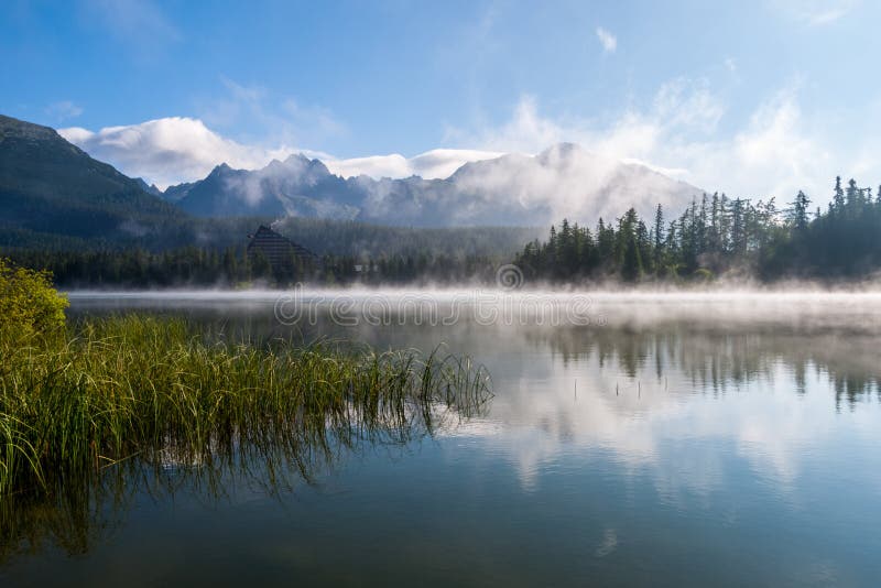 Morning mist above Strbske pleso mountain lake