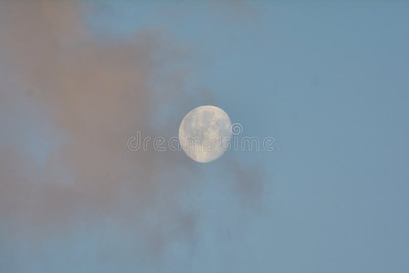 Morning moon in pink clouds