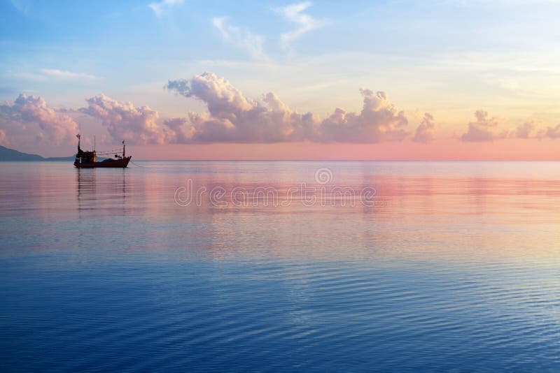 Morning sunrise pink sky, blue sea, white clouds, ship silhouette, scenery landscape, soft color sunset on ocean coast, Thailand
