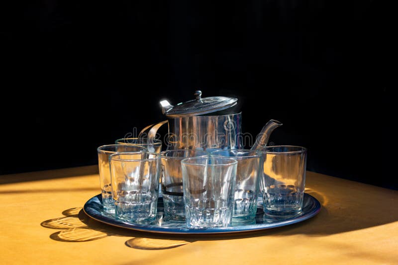 Moroccan Tea Set with Glasses in front of a Black Background stock photos Moroccan Tea Set with Glasses in front of a Black Background stock photos